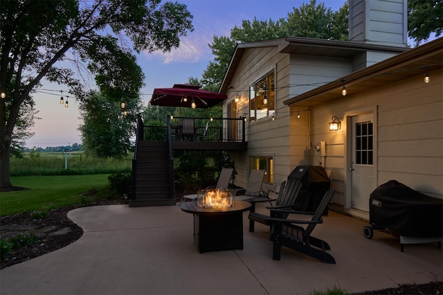 view of patio / terrace with stairs, a fire pit, and a wooden deck