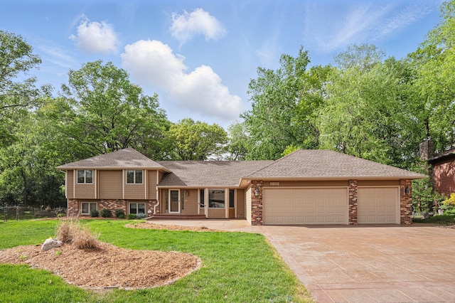 8681 144th Street Ct, Apple Valley, MN 55124 - split level home featuring an attached garage, driveway, and brick siding