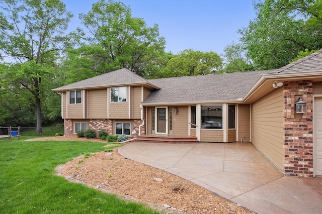 8681 144th Street Ct, Apple Valley, MN 55124 - back of house featuring roof with shingles and brick siding