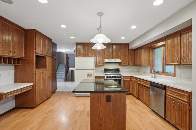 8681 144th Street Ct, Apple Valley, MN 55124 - kitchen featuring stainless steel appliances, ventilation hood, a sink, a kitchen island, and light wood-style flooring