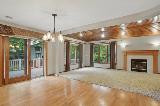 8681 144th Street Ct, Apple Valley, MN 55124 - unfurnished living room featuring wooden ceiling, wood finished floors, a fireplace, a chandelier, and baseboards
