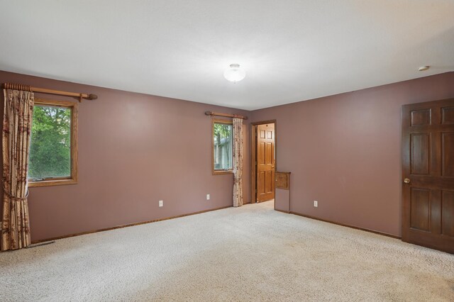 8681 144th Street Ct, Apple Valley, MN 55124 - carpeted empty room featuring plenty of natural light and baseboards