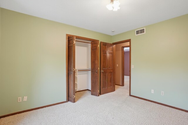 8681 144th Street Ct, Apple Valley, MN 55124 - unfurnished bedroom featuring a closet, light carpet, and baseboards