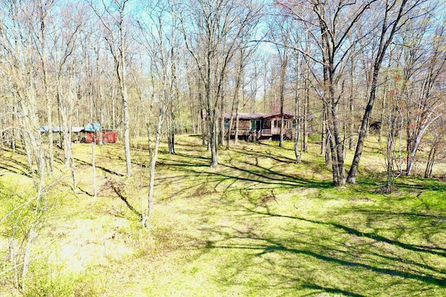 1940 Soper Lake Ln, Clear Creek Unorg Terr, MN 55749 - view of green lawn featuring a deck and a view of trees