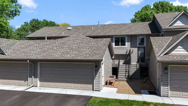 8754 Cottonwood Ln N, Maple Grove, MN 55369 - view of front of house featuring roof with shingles and asphalt driveway