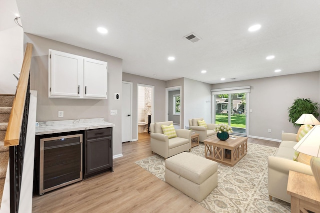 8754 Cottonwood Ln N, Maple Grove, MN 55369 - living area featuring wine cooler, recessed lighting, light wood-style flooring, baseboards, and stairs