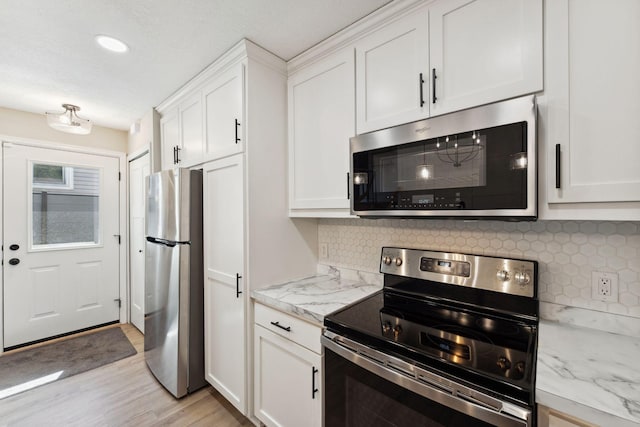 8754 Cottonwood Ln N, Maple Grove, MN 55369 - kitchen featuring stainless steel appliances, white cabinets, light wood-type flooring, backsplash, and recessed lighting