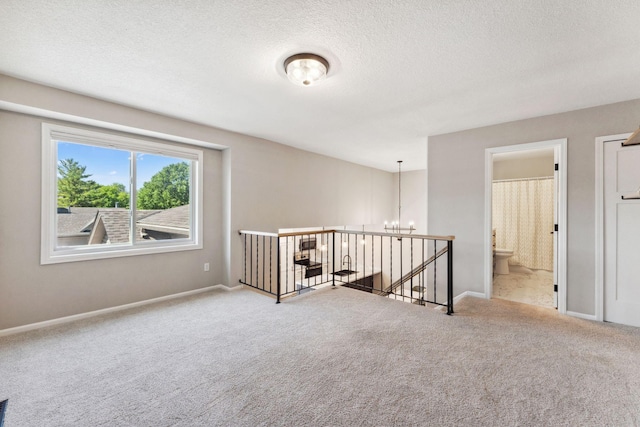 8754 Cottonwood Ln N, Maple Grove, MN 55369 - carpeted empty room featuring a chandelier, baseboards, and a textured ceiling