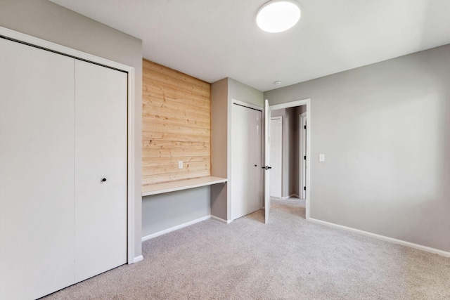8754 Cottonwood Ln N, Maple Grove, MN 55369 - unfurnished bedroom with carpet flooring, baseboards, and multiple closets