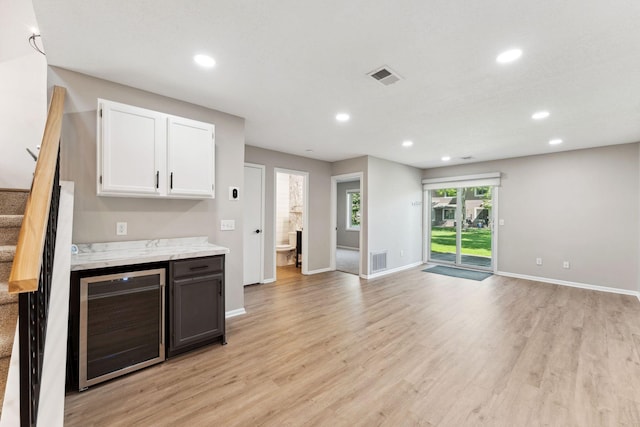 8754 Cottonwood Ln N, Maple Grove, MN 55369 - kitchen featuring wine cooler, white cabinets, recessed lighting, light wood finished floors, and baseboards