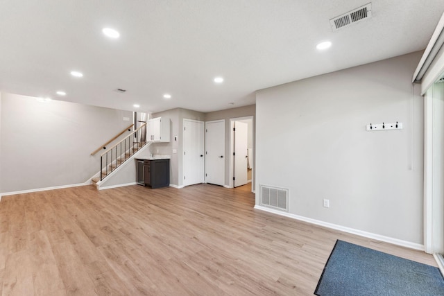 8754 Cottonwood Ln N, Maple Grove, MN 55369 - unfurnished living room with recessed lighting, baseboards, stairway, and light wood finished floors