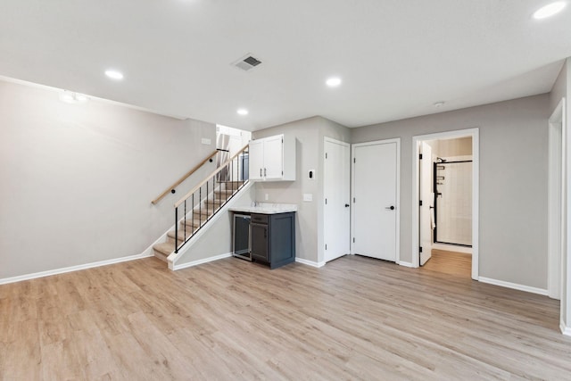8754 Cottonwood Ln N, Maple Grove, MN 55369 - unfurnished living room featuring stairway, light wood-style flooring, baseboards, and recessed lighting
