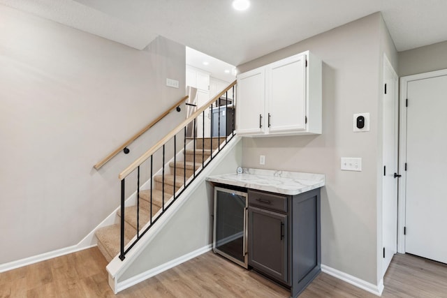 8754 Cottonwood Ln N, Maple Grove, MN 55369 - bar area featuring beverage cooler, light wood finished floors, baseboards, stairway, and recessed lighting