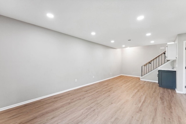 8754 Cottonwood Ln N, Maple Grove, MN 55369 - unfurnished living room with light wood-style floors, recessed lighting, baseboards, and stairs