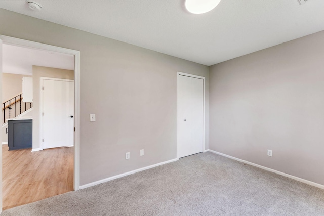 8754 Cottonwood Ln N, Maple Grove, MN 55369 - unfurnished room with baseboards, light carpet, and a smoke detector