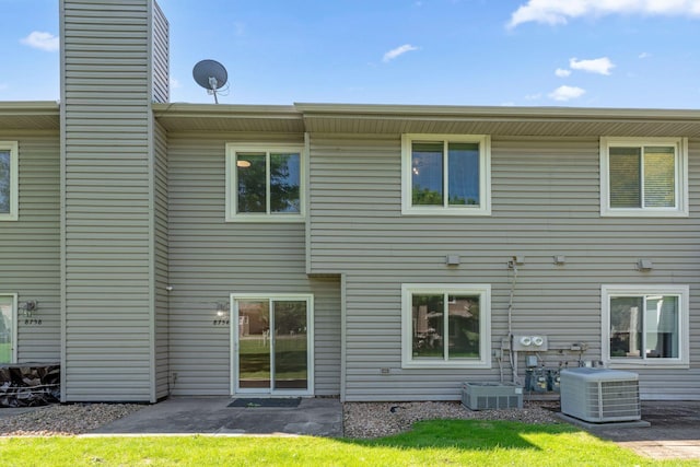 8754 Cottonwood Ln N, Maple Grove, MN 55369 - rear view of house featuring central AC unit, a chimney, and a patio