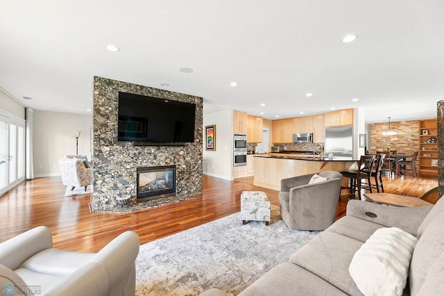 2501 30th Ave S Unit 201, Fargo, ND 58103 - living room with light wood finished floors, recessed lighting, a fireplace, and baseboards