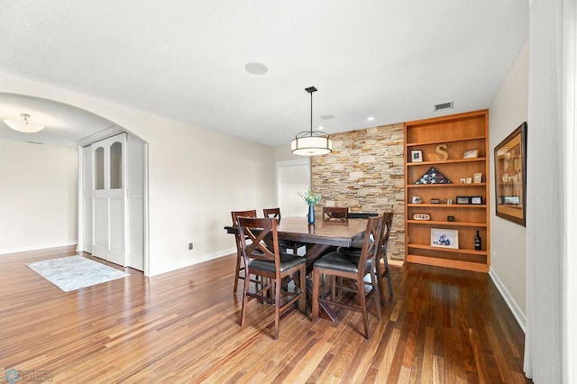 2501 30th Ave S Unit 201, Fargo, ND 58103 - dining space with arched walkways, wood finished floors, and baseboards