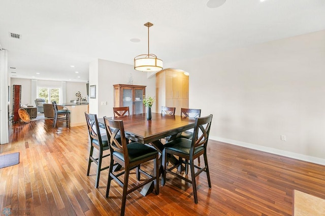 2501 30th Ave S Unit 201, Fargo, ND 58103 - dining area with wood finished floors, arched walkways, and baseboards