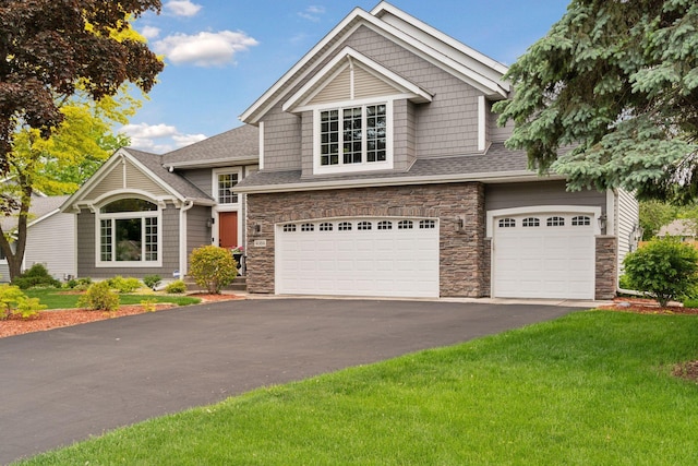 4084 Wild Goose Ln, White Bear Twp, MN 55110 - craftsman inspired home with driveway, a garage, stone siding, and a front yard