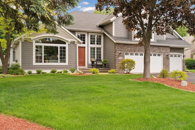 4084 Wild Goose Ln, White Bear Twp, MN 55110 - view of front of house featuring a front lawn, driveway, roof with shingles, and stone siding