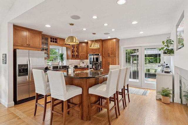 4084 Wild Goose Ln, White Bear Twp, MN 55110 - kitchen with appliances with stainless steel finishes, brown cabinetry, plenty of natural light, and recessed lighting