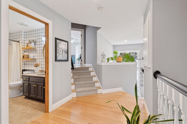 4084 Wild Goose Ln, White Bear Twp, MN 55110 - hallway with stairs, baseboards, and a textured ceiling