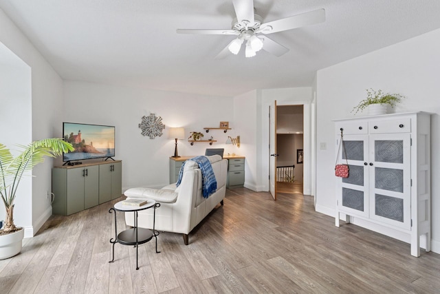 4084 Wild Goose Ln, White Bear Twp, MN 55110 - living room with light wood-style flooring, ceiling fan, and baseboards