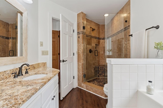 4084 Wild Goose Ln, White Bear Twp, MN 55110 - bathroom featuring vanity, a stall shower, wood finished floors, a garden tub, and toilet
