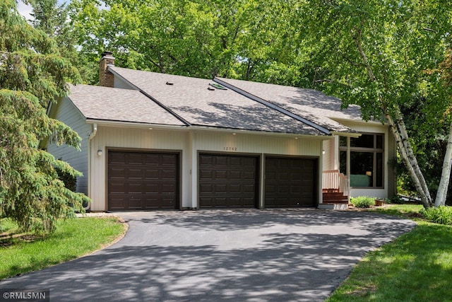 12762 Foliage Ave, Apple Valley, MN 55124 - mid-century inspired home featuring driveway, roof with shingles, a chimney, and a garage