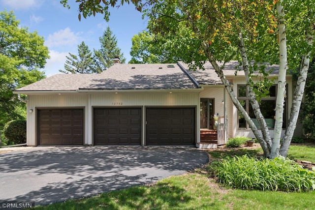 12762 Foliage Ave, Apple Valley, MN 55124 - view of front of home with asphalt driveway, a chimney, an attached garage, and a shingled roof