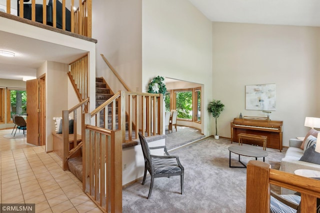 12762 Foliage Ave, Apple Valley, MN 55124 - carpeted living room with a towering ceiling, healthy amount of natural light, stairway, and baseboards