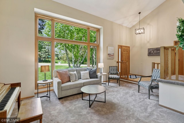 12762 Foliage Ave, Apple Valley, MN 55124 - living area with carpet floors, high vaulted ceiling, a chandelier, and baseboards