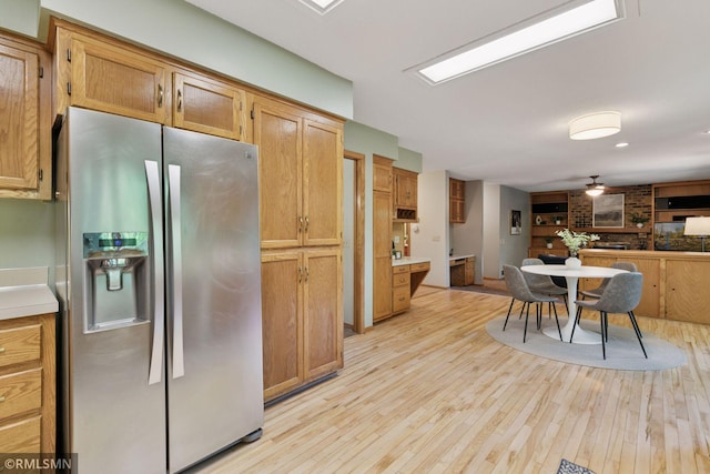 12762 Foliage Ave, Apple Valley, MN 55124 - kitchen with stainless steel fridge with ice dispenser, open floor plan, light wood-style flooring, ceiling fan, and light countertops