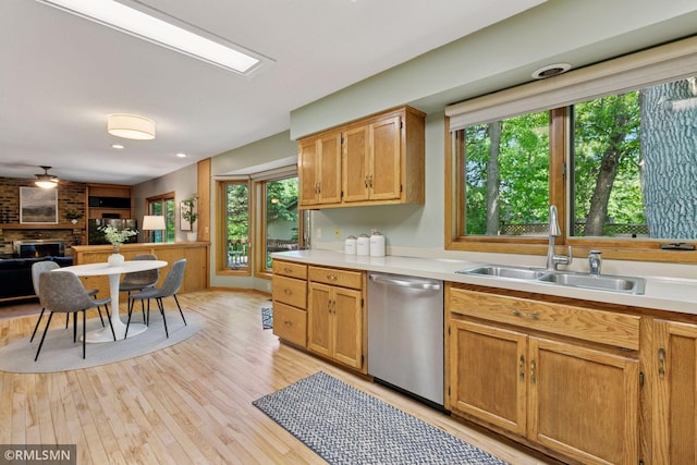 12762 Foliage Ave, Apple Valley, MN 55124 - kitchen featuring dishwasher, a sink, light countertops, and a fireplace