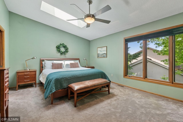 12762 Foliage Ave, Apple Valley, MN 55124 - carpeted bedroom featuring a skylight, baseboards, lofted ceiling, and a ceiling fan