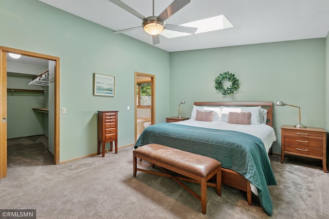 12762 Foliage Ave, Apple Valley, MN 55124 - carpeted bedroom featuring a skylight, a walk in closet, ceiling fan, baseboards, and ensuite bathroom