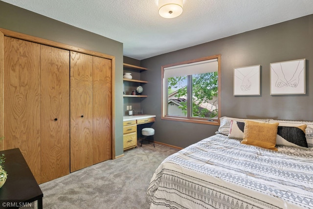 12762 Foliage Ave, Apple Valley, MN 55124 - bedroom with light carpet, a closet, a textured ceiling, baseboards, and a desk