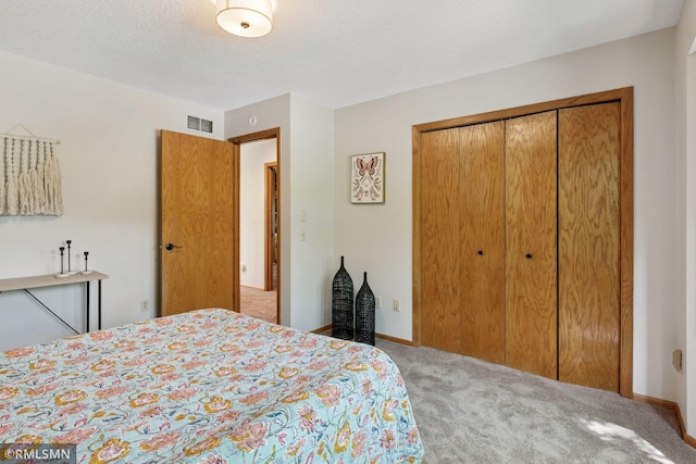 12762 Foliage Ave, Apple Valley, MN 55124 - bedroom featuring carpet floors, a closet, baseboards, and a textured ceiling