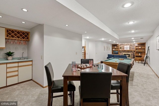 12762 Foliage Ave, Apple Valley, MN 55124 - dining space with wet bar, light carpet, recessed lighting, a fireplace, and baseboards