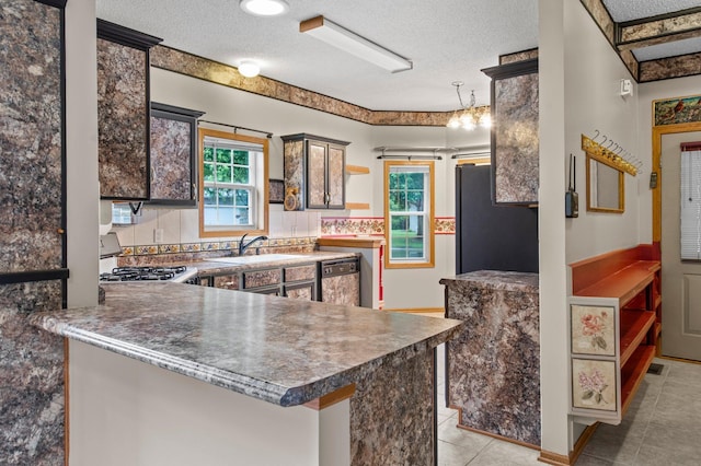 351 100th Ct NE, Blaine, MN 55434 - kitchen featuring freestanding refrigerator, stove, dishwasher, a textured ceiling, and dark countertops