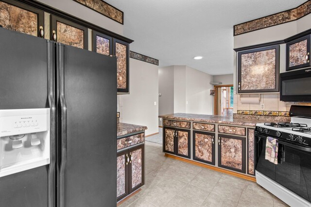 351 100th Ct NE, Blaine, MN 55434 - kitchen featuring fridge with ice dispenser, range with gas cooktop, black microwave, dark countertops, and light tile patterned floors