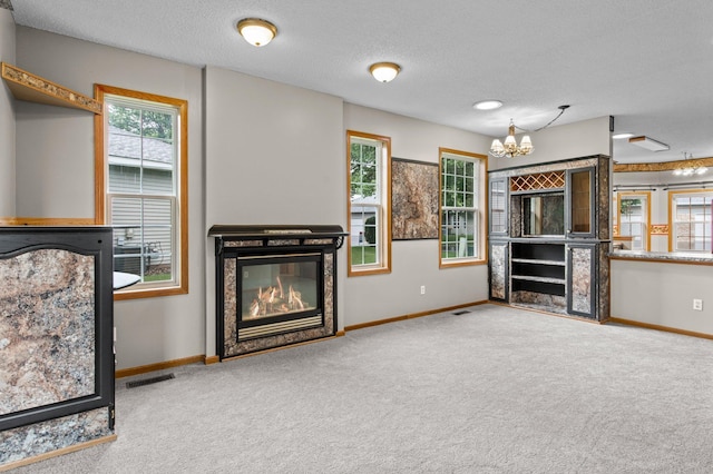 351 100th Ct NE, Blaine, MN 55434 - carpeted living area with healthy amount of natural light, a textured ceiling, and a chandelier