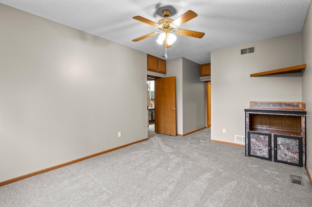 351 100th Ct NE, Blaine, MN 55434 - unfurnished living room with light carpet, a ceiling fan, and a textured ceiling