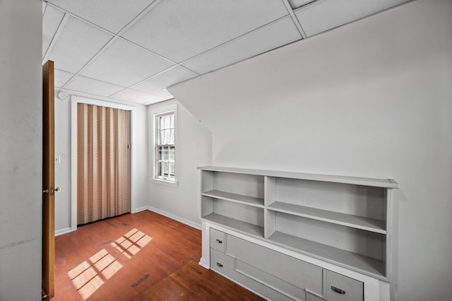 bonus room with wood finished floors and baseboards