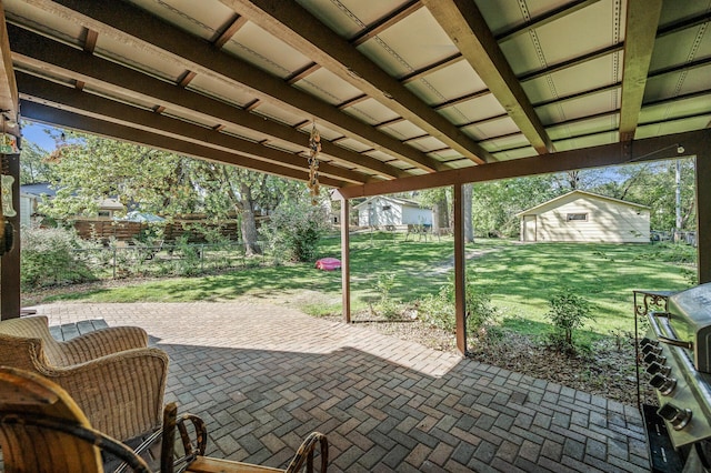 view of patio / terrace with an outbuilding and a grill