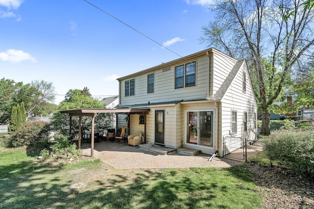 rear view of property with a patio, entry steps, and a gate
