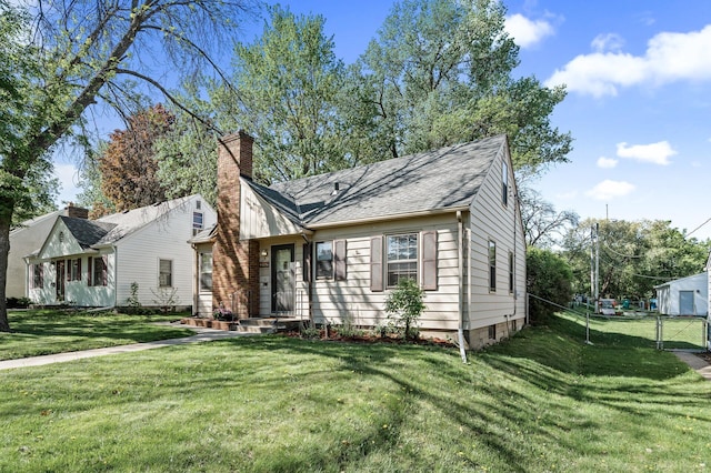 view of front of house with a gate and a chimney