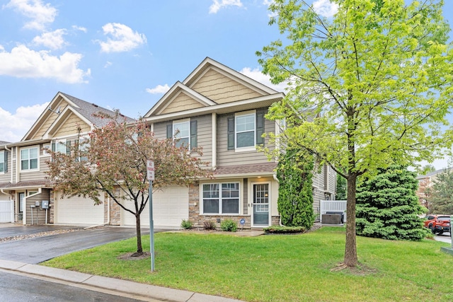 2119 Cedar Grove Trl, Eagan, MN 55122 - view of front of house featuring asphalt driveway, a garage, a front lawn, and central air condition unit