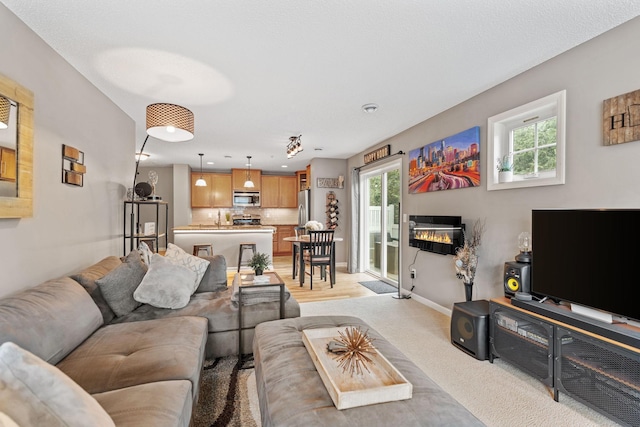 2119 Cedar Grove Trl, Eagan, MN 55122 - living room with plenty of natural light, light colored carpet, baseboards, and a glass covered fireplace